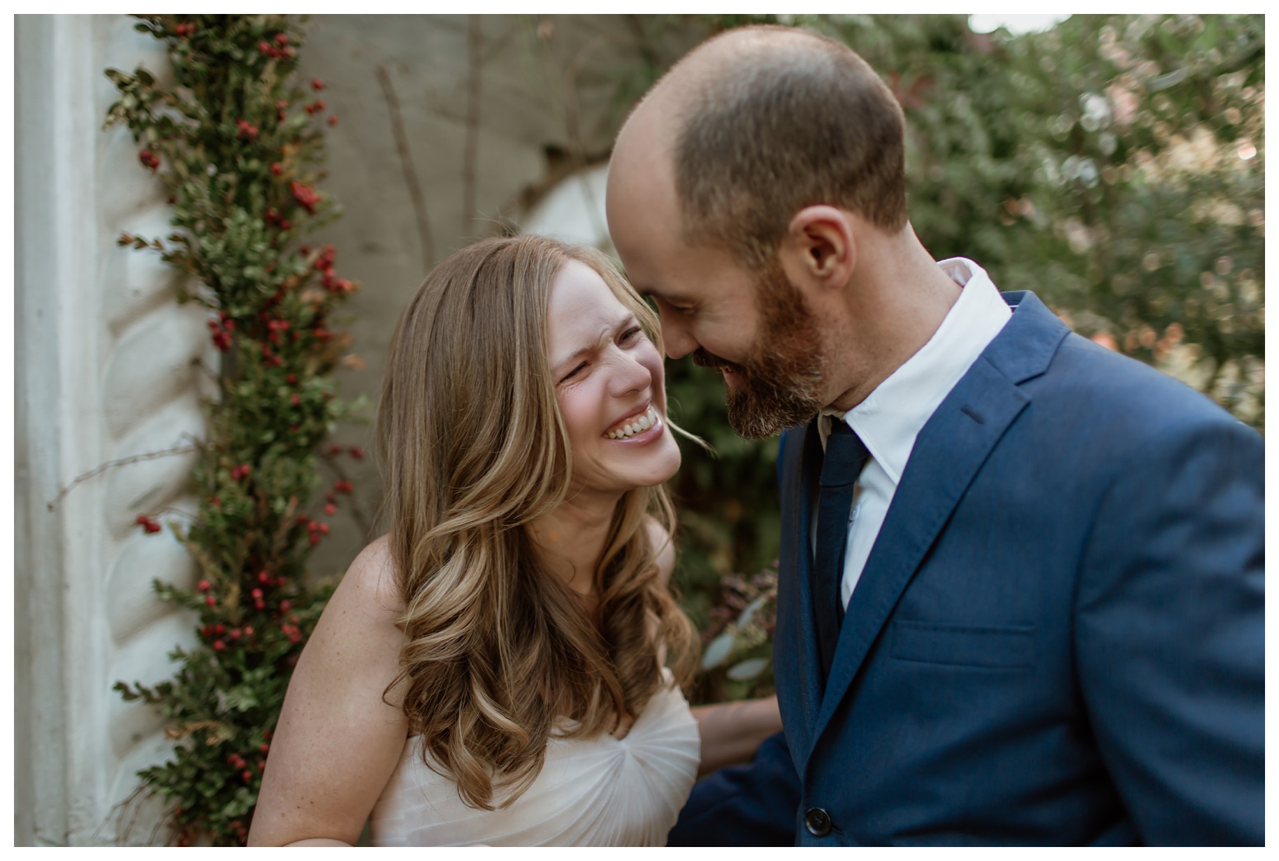 The bride and groom share a joyful and intimate moment, laughing together during their first look. Their genuine happiness and connection shine through, making this a beautiful reminder of why couples ask, "Should we do a first look on our wedding day?"—for moments like this that ease nerves and create unforgettable memories.