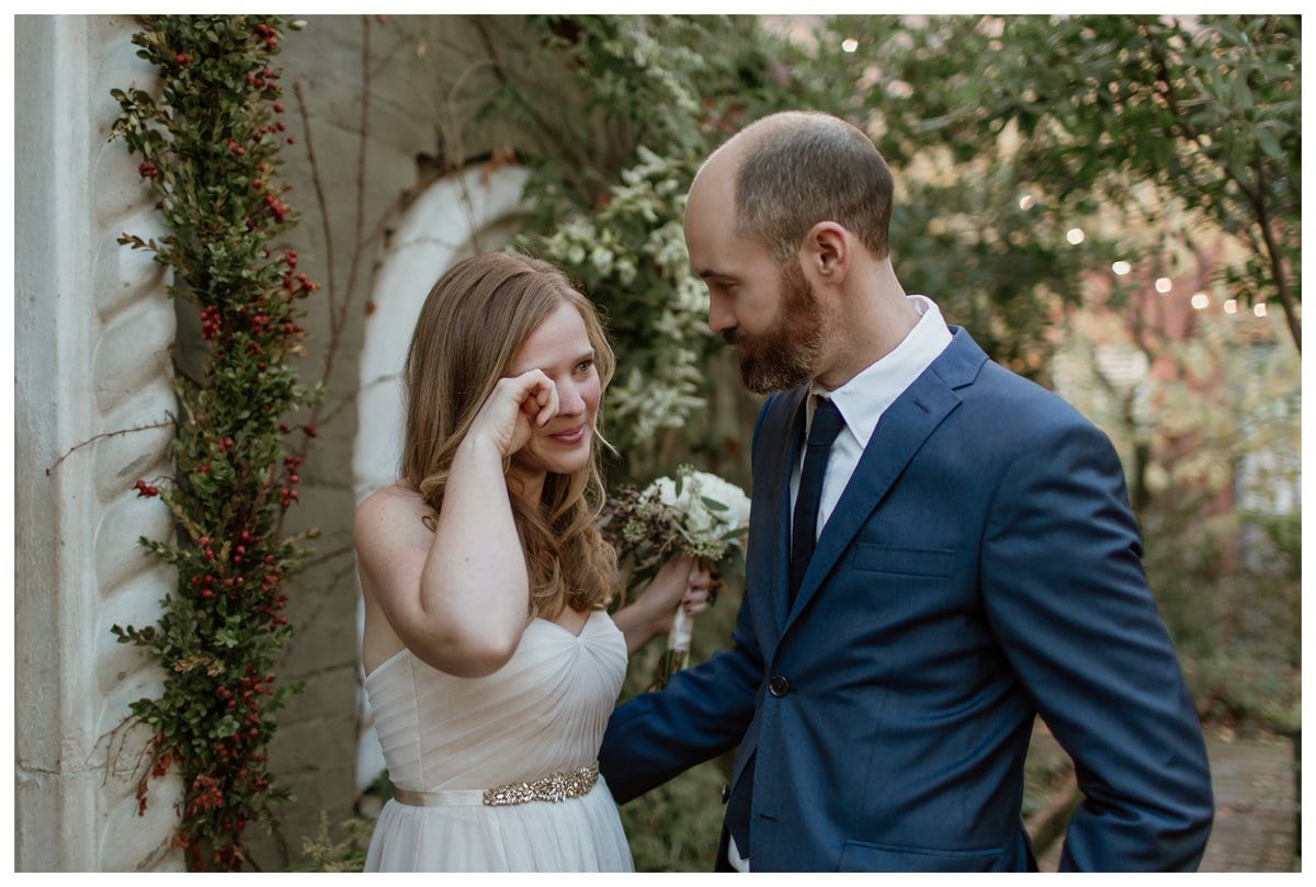 With tears of joy, the bride wipes away an emotional moment as she and her groom share their first look.  If you're asking, "Should we do a first look on our wedding day?"—this touching moment is a perfect reason why it can be so special.