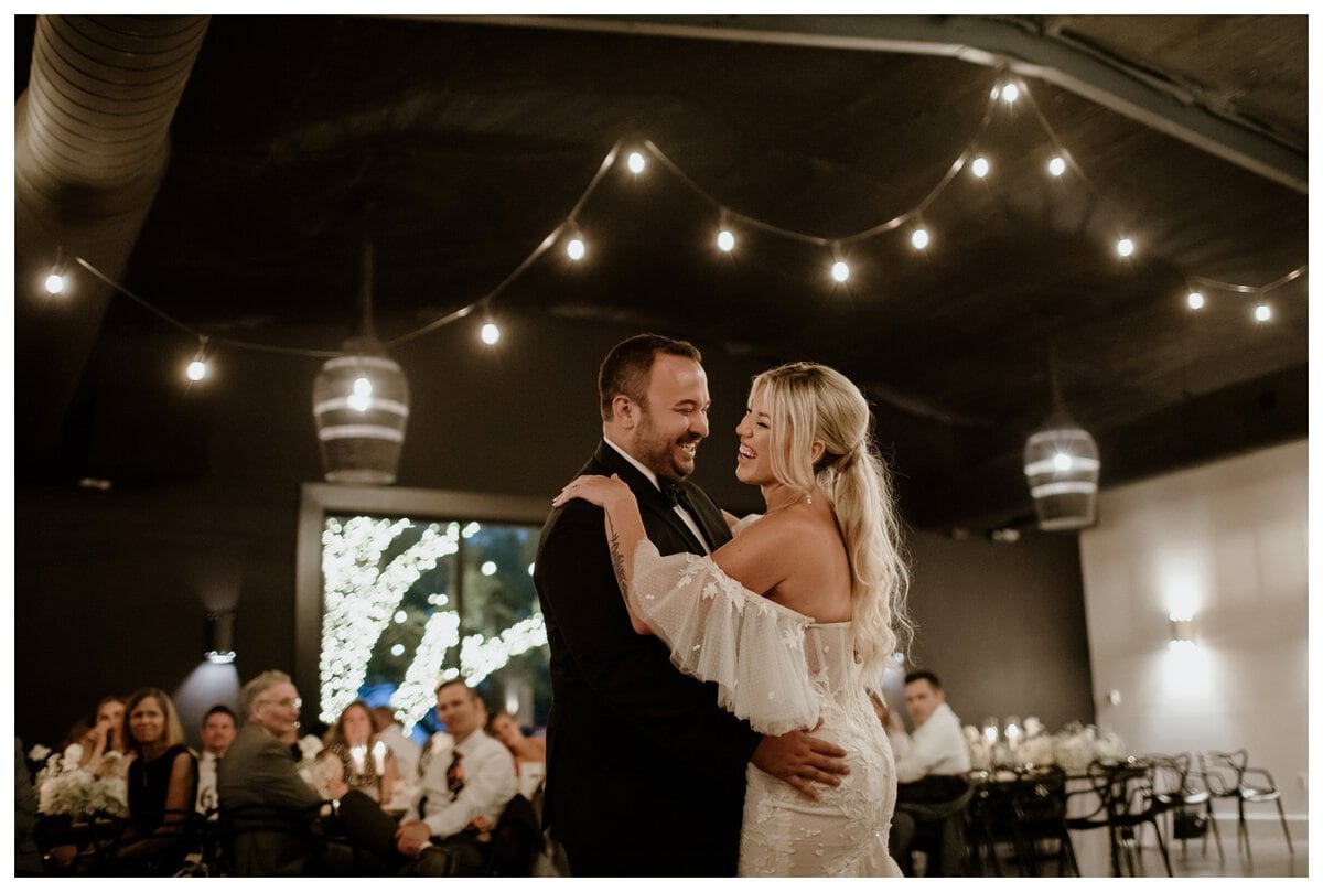 A beaming couple shares their first dance at Lazy S Hacienda, surrounded by romantic string lights and a warm ambiance. Their joy perfectly captures the magic of cool first dance songs that make wedding moments unforgettable.