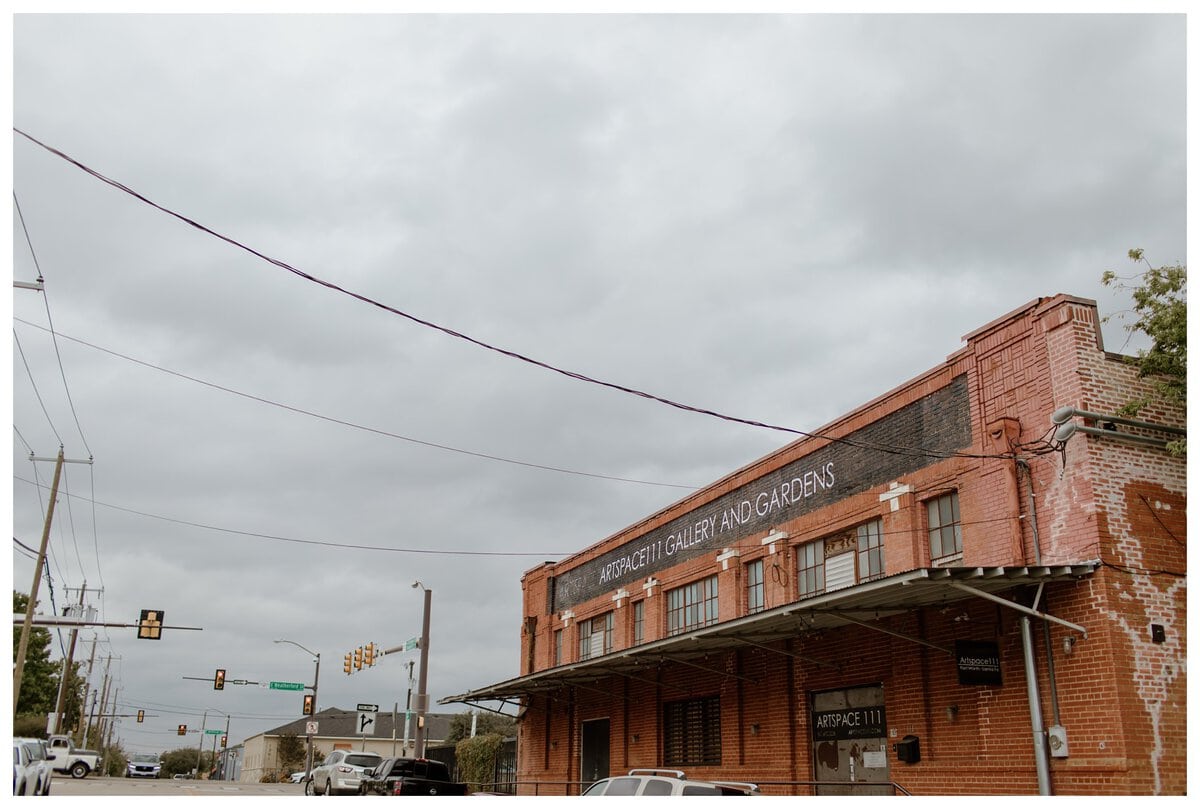 Exterior view of Artspace111 wedding venue showcasing its industrial aesthetic with a rustic brick facade and urban surroundings.