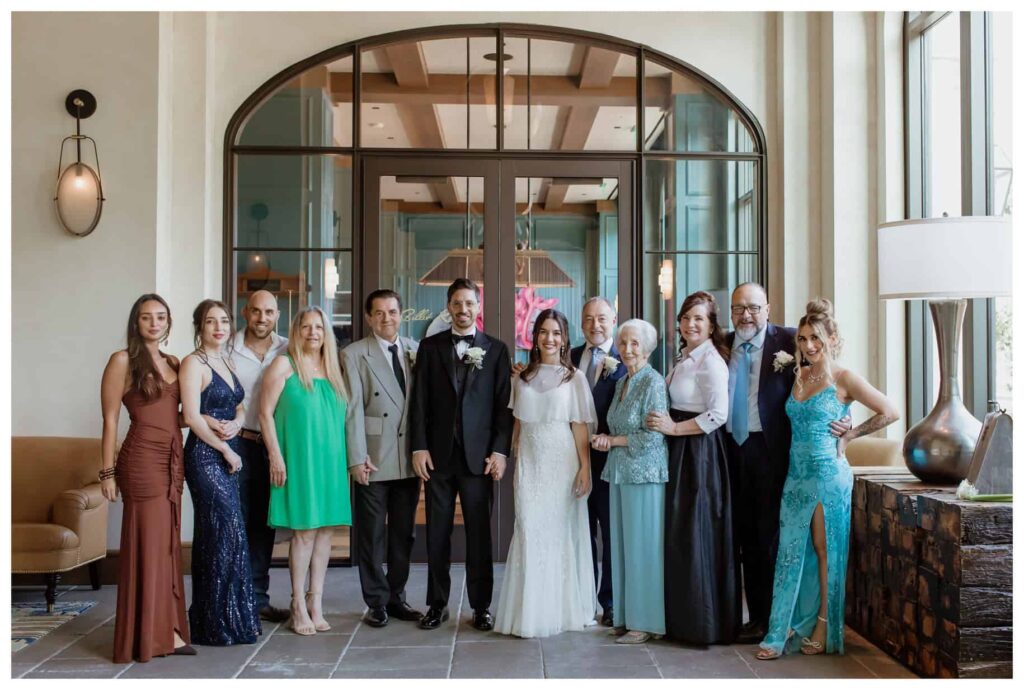 Multi-generational wedding family photo with adults dressed in formal attire, captured by a Fort Worth wedding photographer.