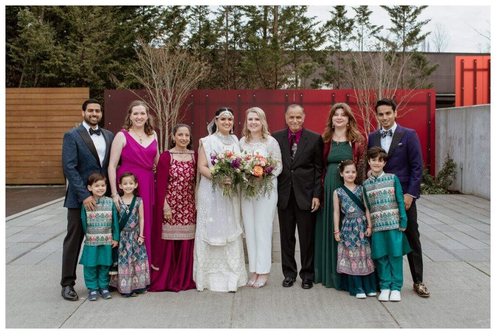 Multi-generational wedding family photo with children and adults dressed in formal and traditional attire, captured by a Fort Worth wedding photographer.